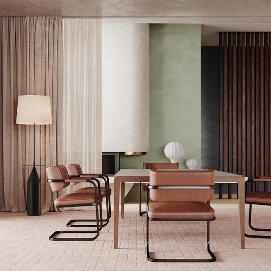 Modern dining room with terracotta chairs, sage green accent wall, wooden table, floor lamp, herringbone flooring