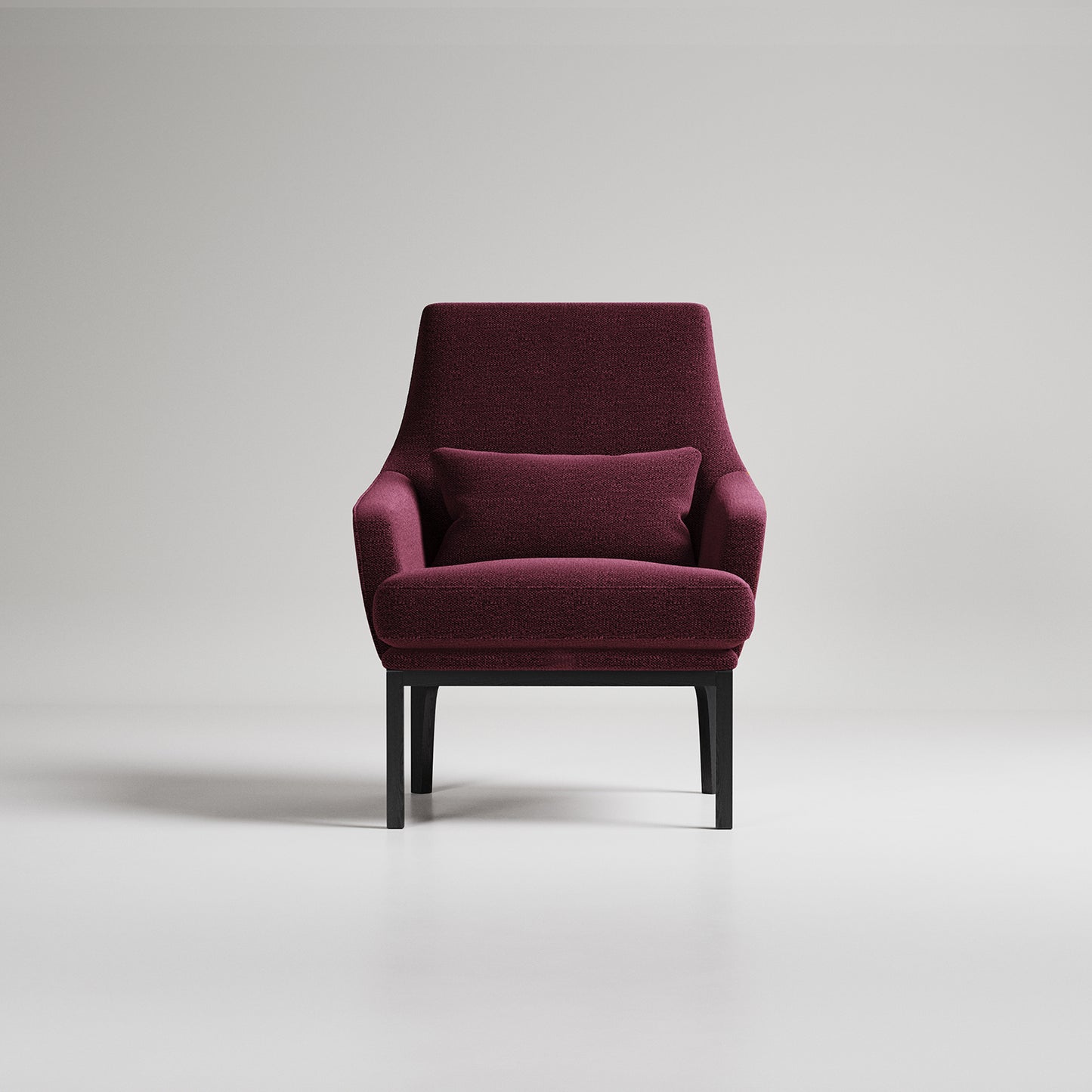 Modern burgundy armchair with black legs on light gray background, studio photography