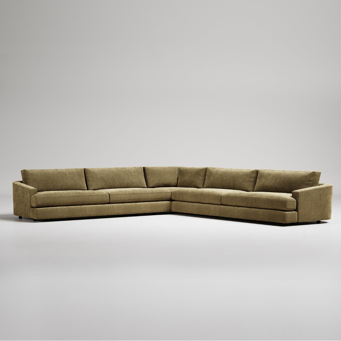 Modern L-shaped sectional sofa in olive green textured fabric against white background