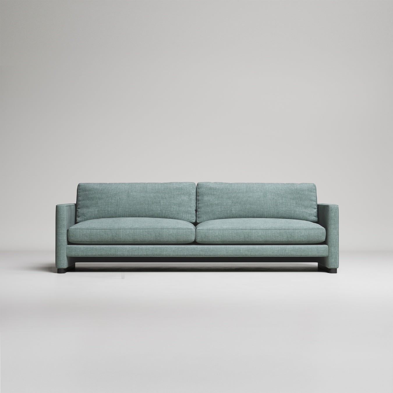 Modern sage green upholstered sofa with clean lines and square arms against neutral gray background
