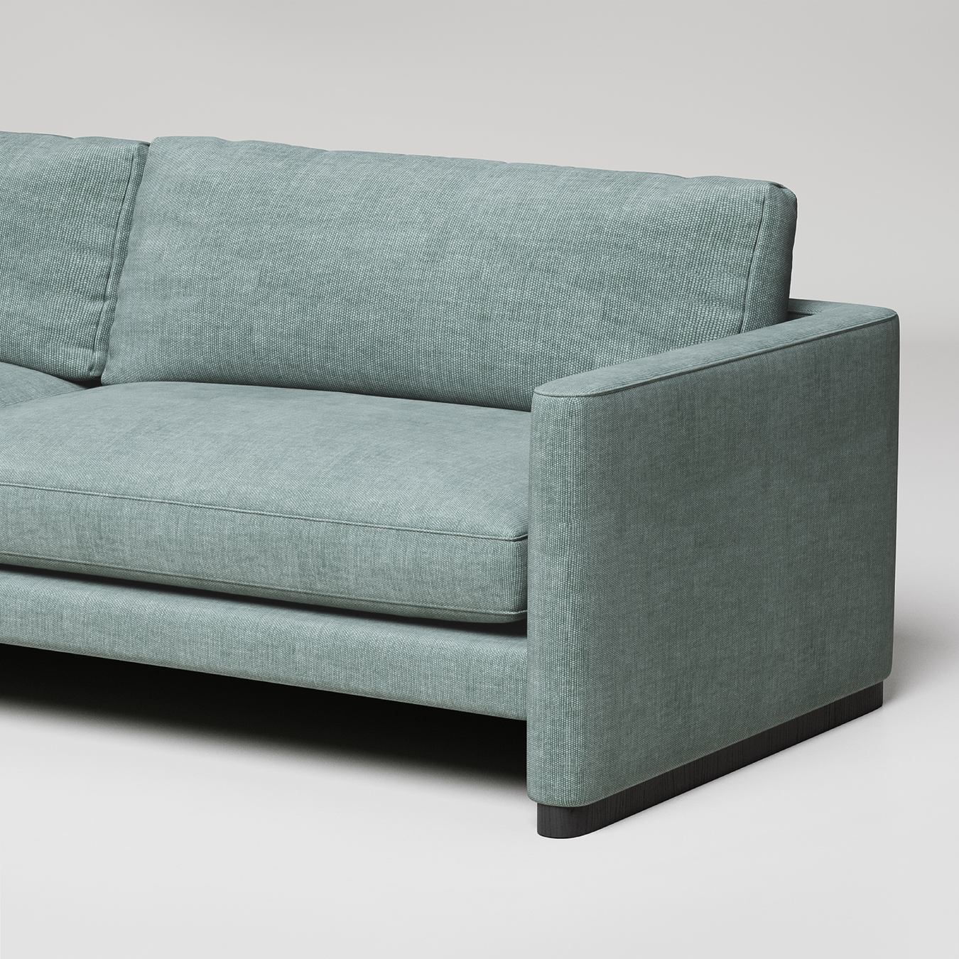 Modern mint green sofa with clean lines, dark wood base, and textured upholstery against white background