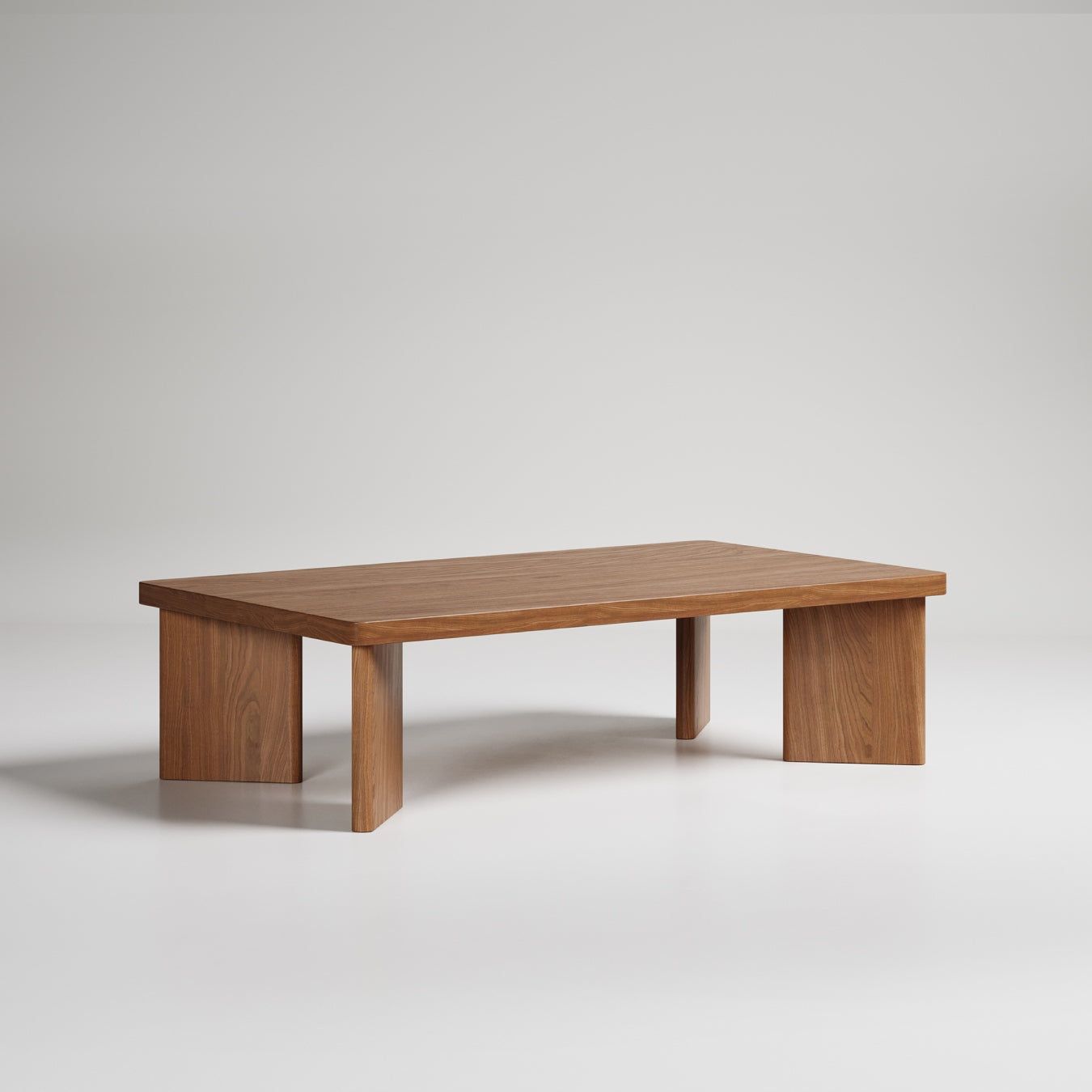 Modern rectangular coffee table with solid wood construction and minimal design, featuring thick block legs
