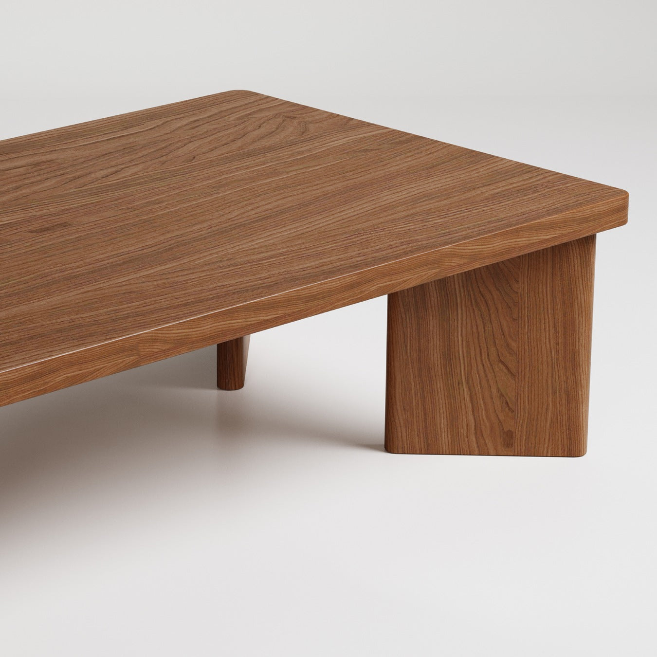 Modern minimalist wood coffee table with thick rectangular top and chunky cylindrical legs against white backdrop