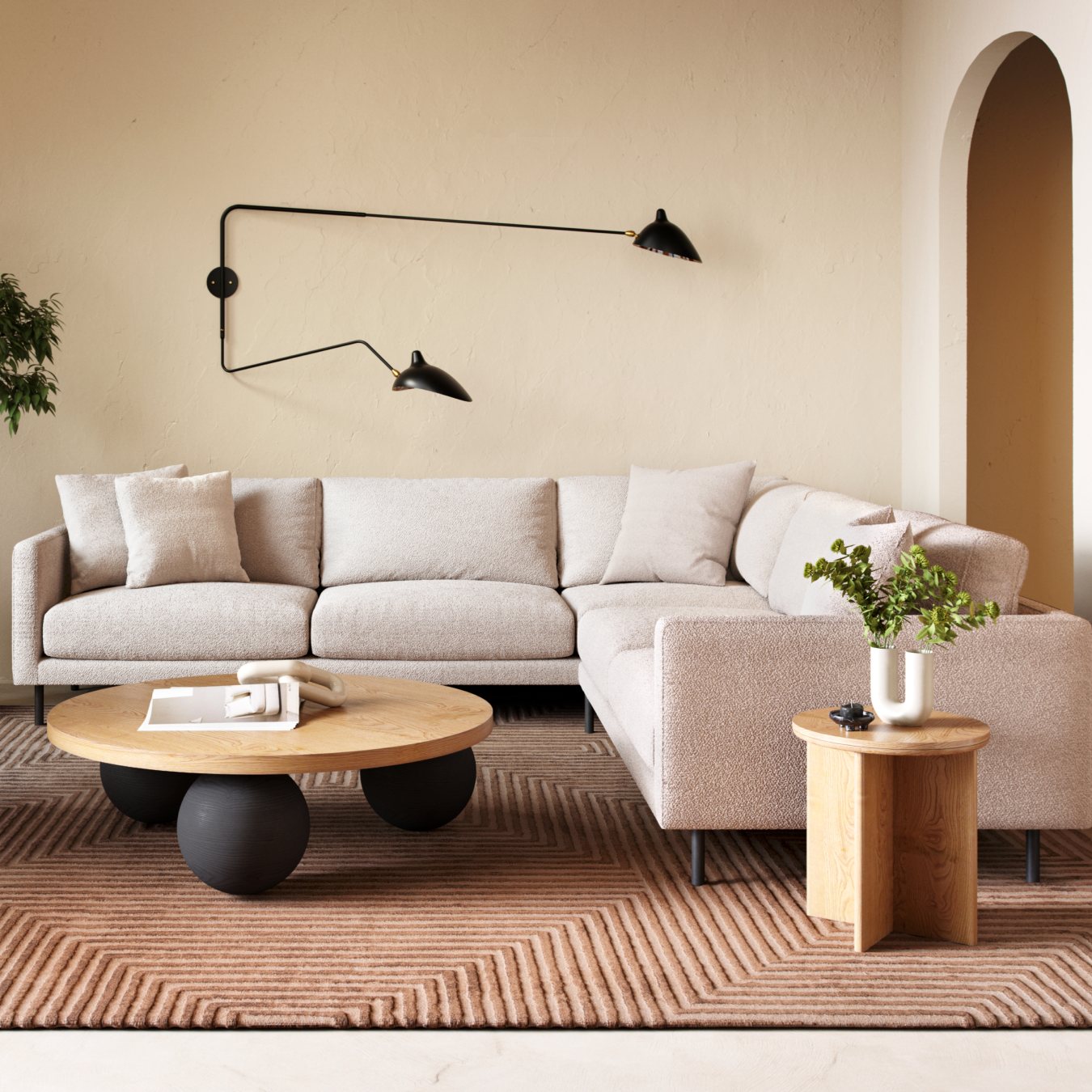 Modern living room with beige sectional, unique round coffee table, geometric rug, and black wall sconces