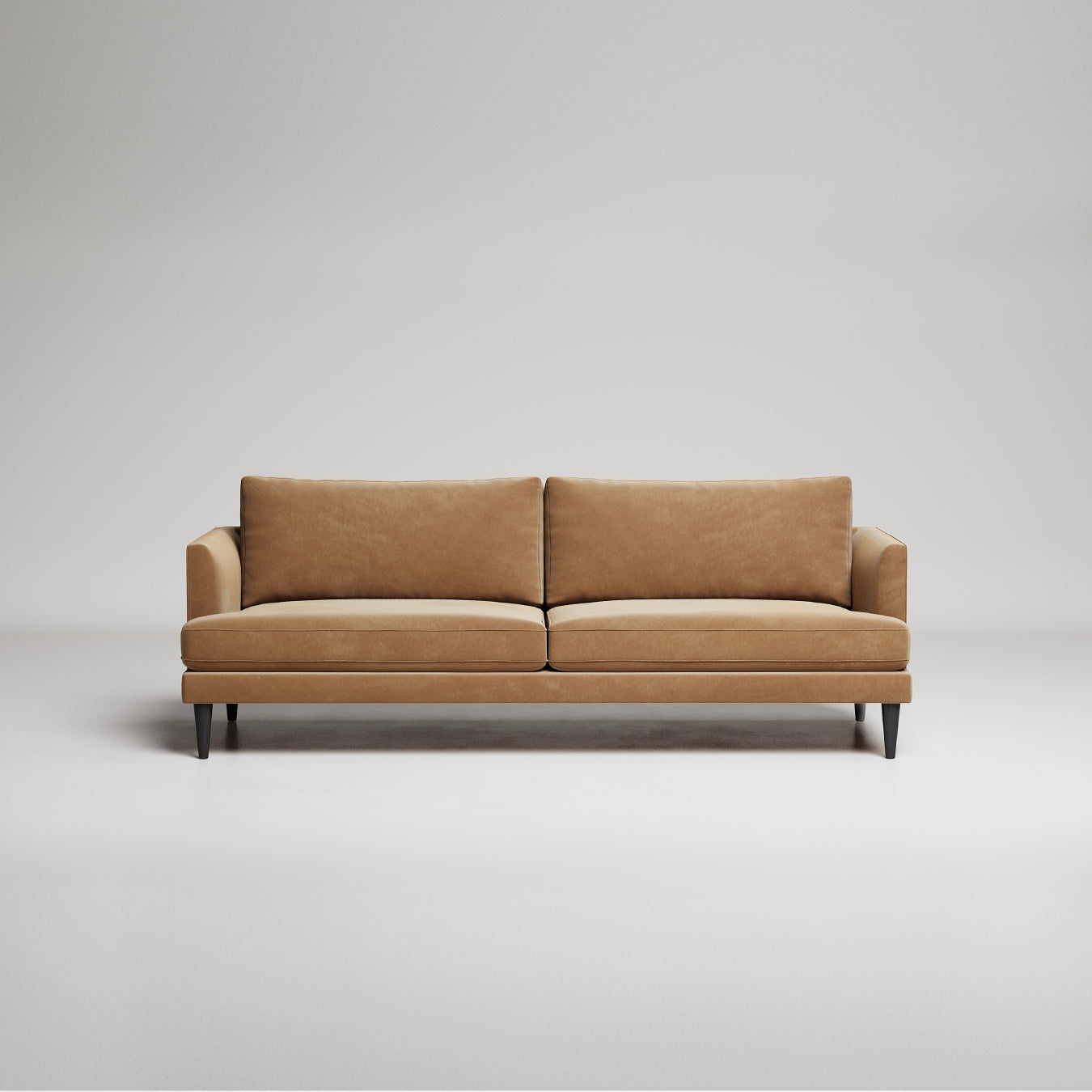 Modern tan leather sofa with slim black legs against neutral gray background, minimalist studio shot