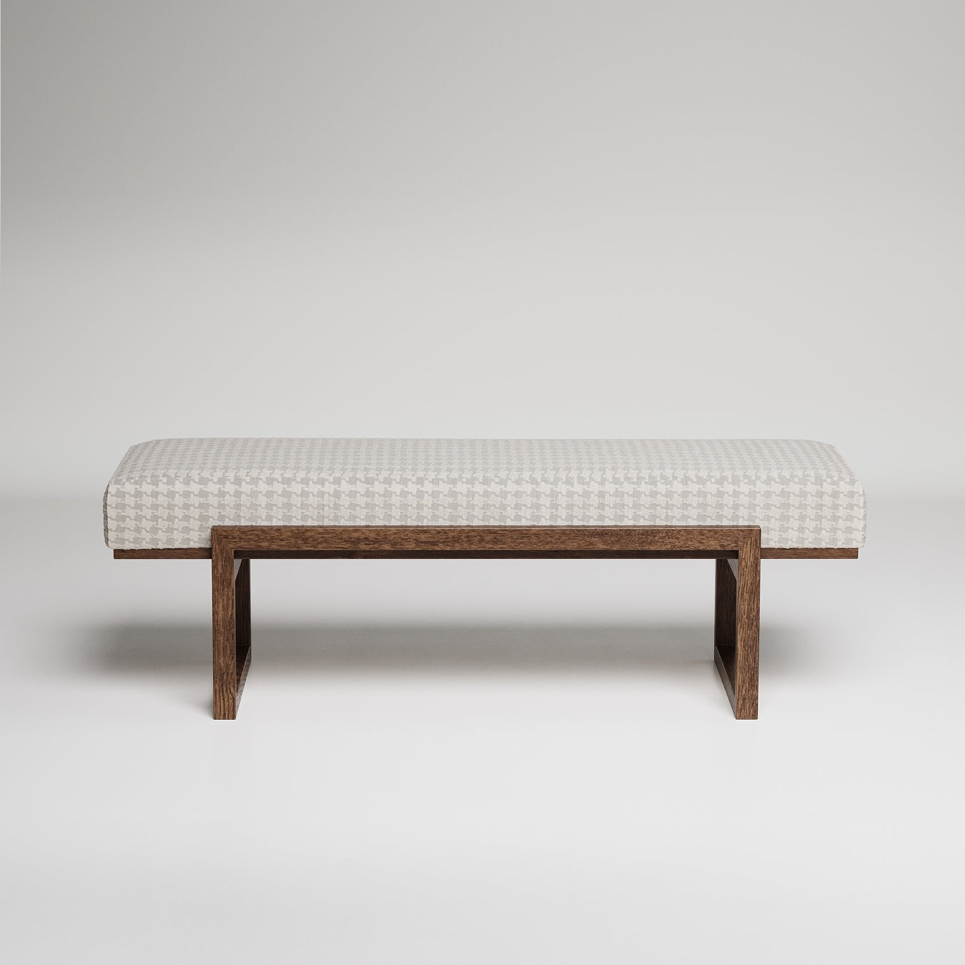 Modern upholstered bench with white houndstooth fabric cushion on minimalist dark wood frame against grey background
