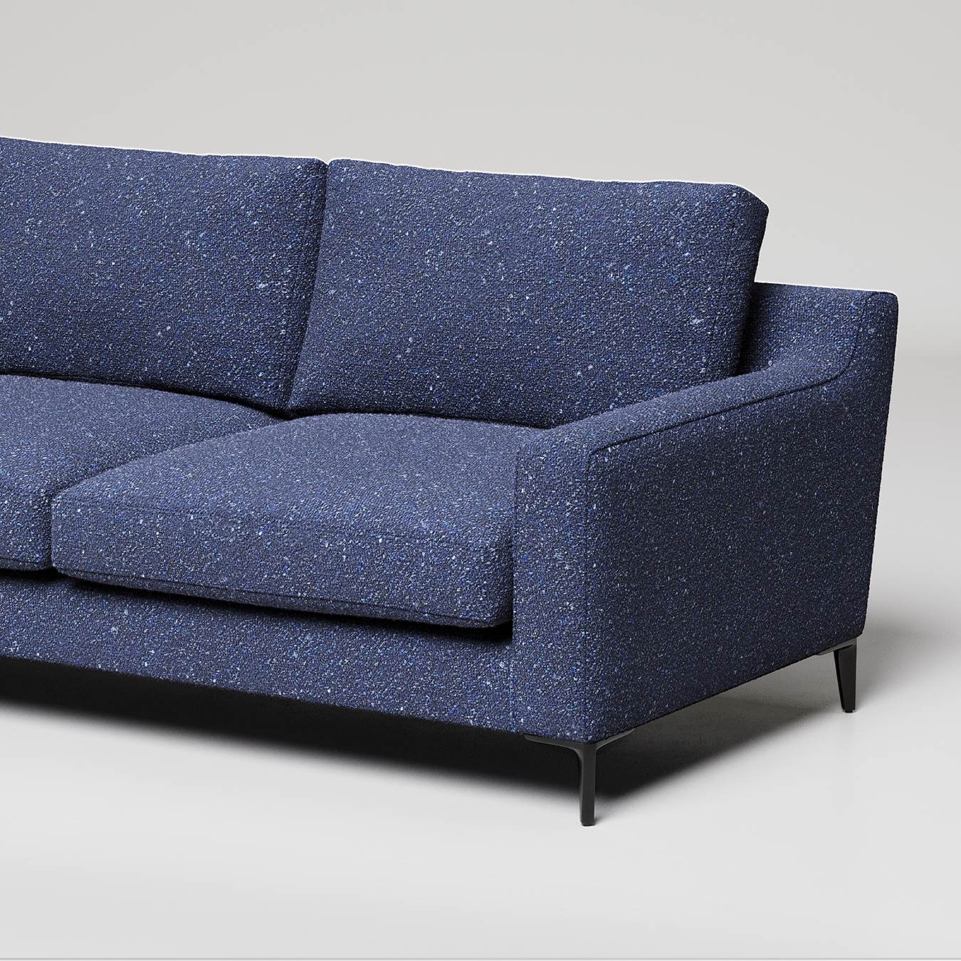 Modern navy blue sofa with speckled fabric texture and slim black metal legs against white background
