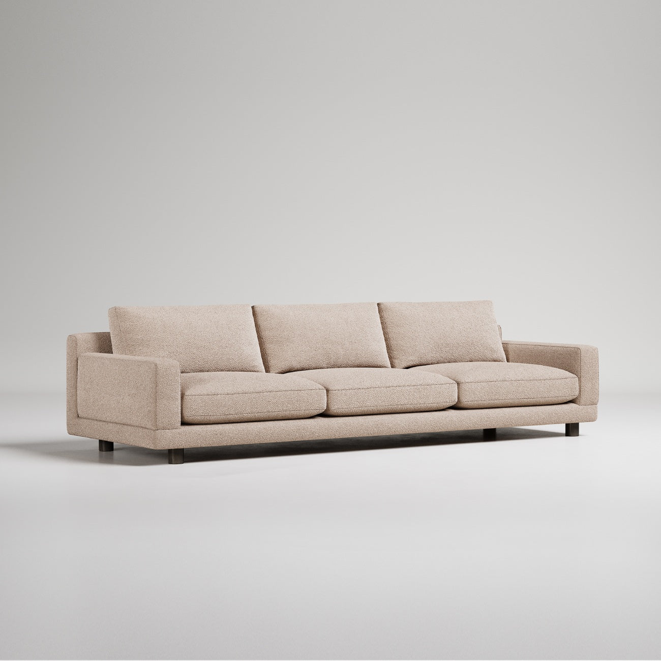 Modern beige three-seater sofa with clean lines and metal feet, photographed on white background