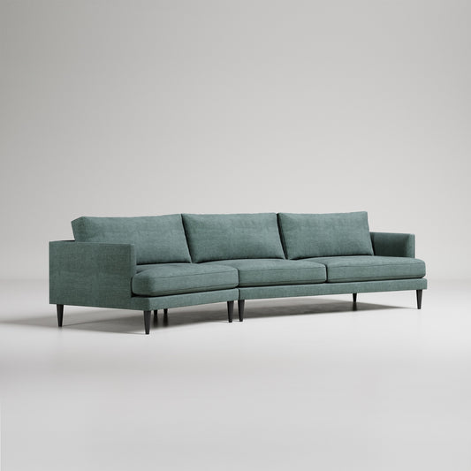 Modern sage green sectional sofa with clean lines, tapered legs, and loose back cushions on light gray background