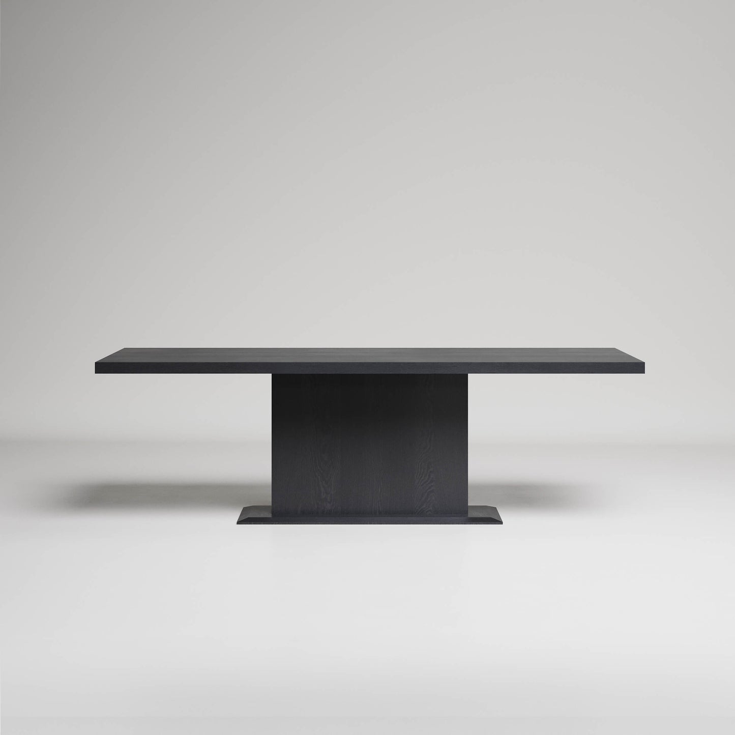 Modern black rectangular dining table with pedestal base on light gray background, minimalist design