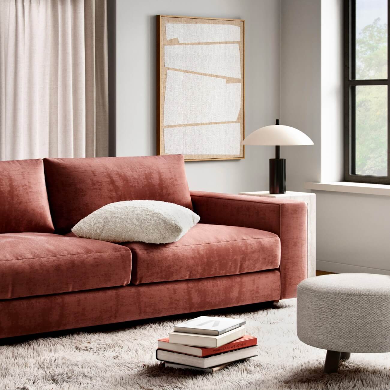 Modern living room with dusty rose velvet sofa, abstract wall art, dome lamp, and shag rug
