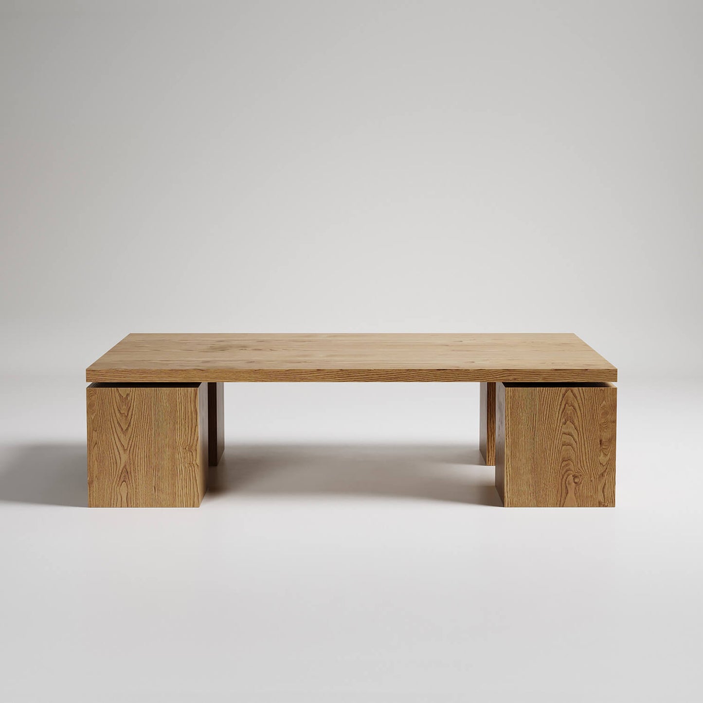 Modern minimalist wooden coffee table with floating top design supported by two cube pedestals against white backdrop