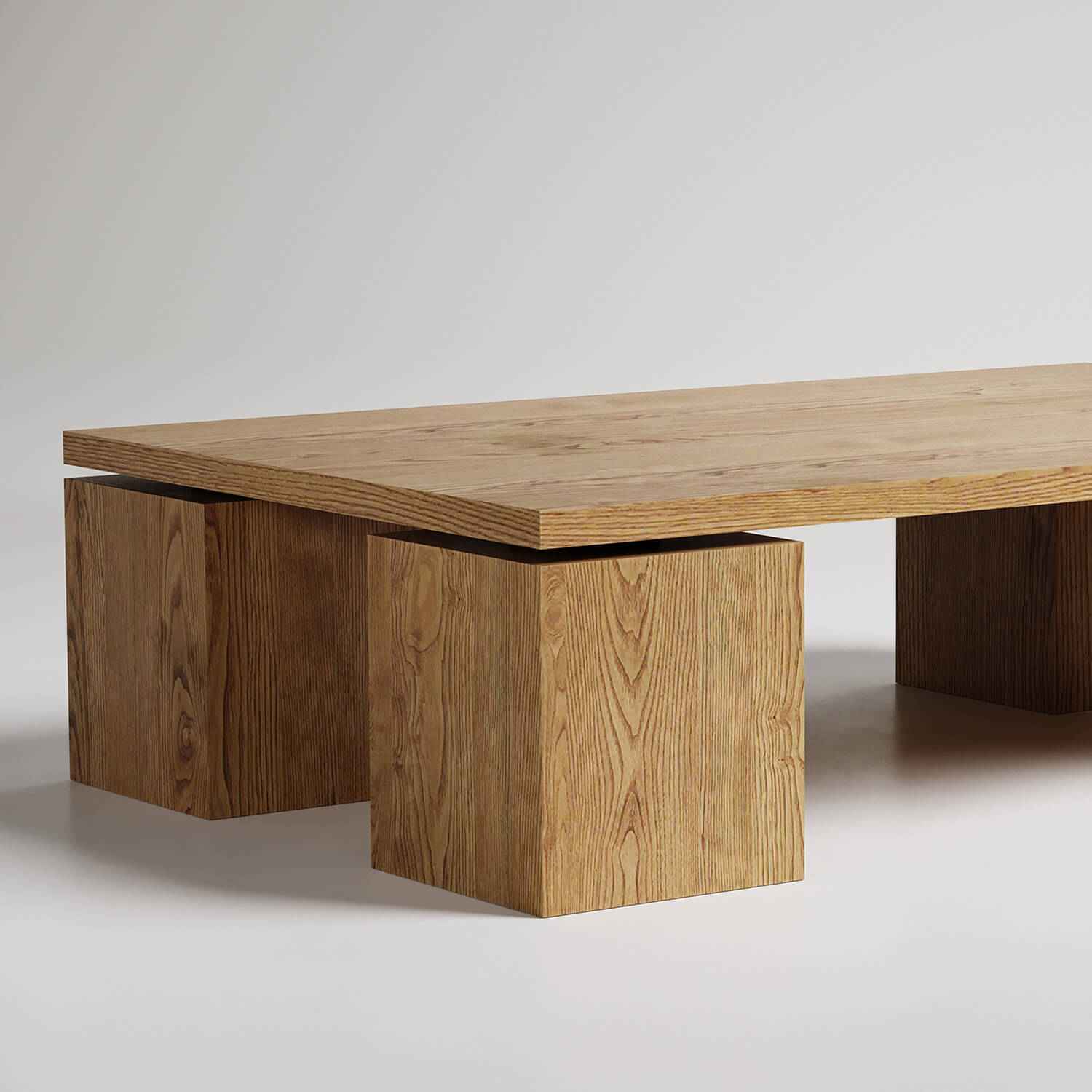 Modern minimalist coffee table with thick wooden top and two geometric cube bases, natural oak finish