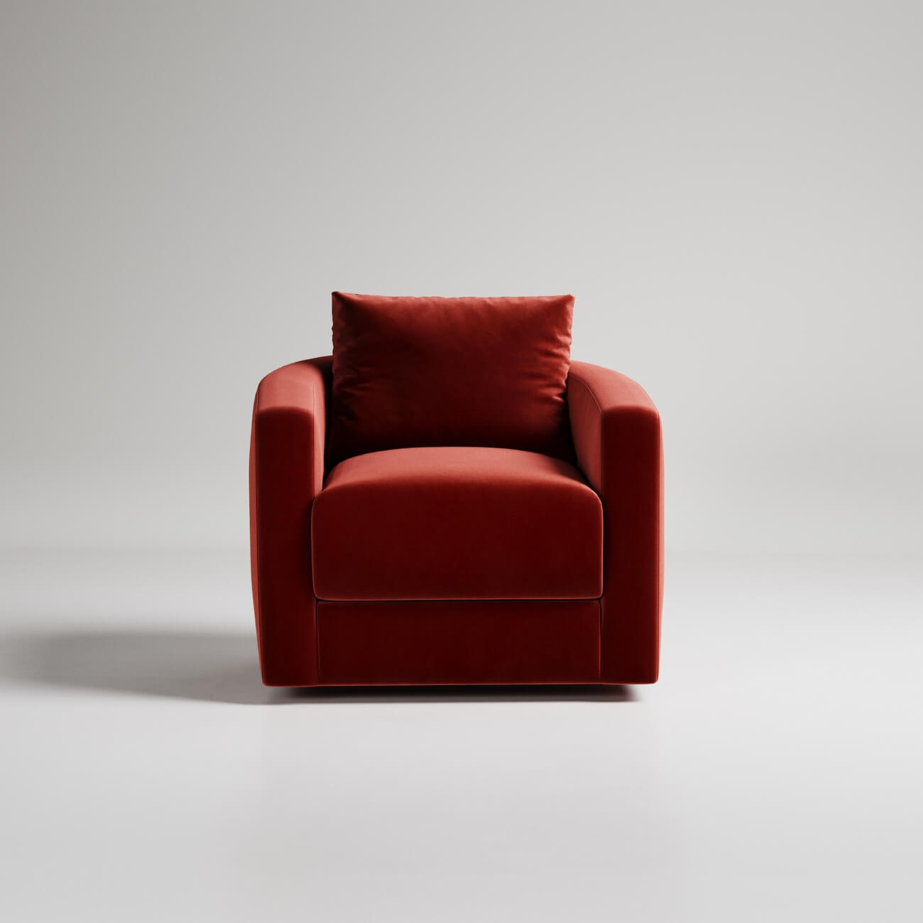 Modern red velvet armchair with clean lines against white background, minimalist furniture design