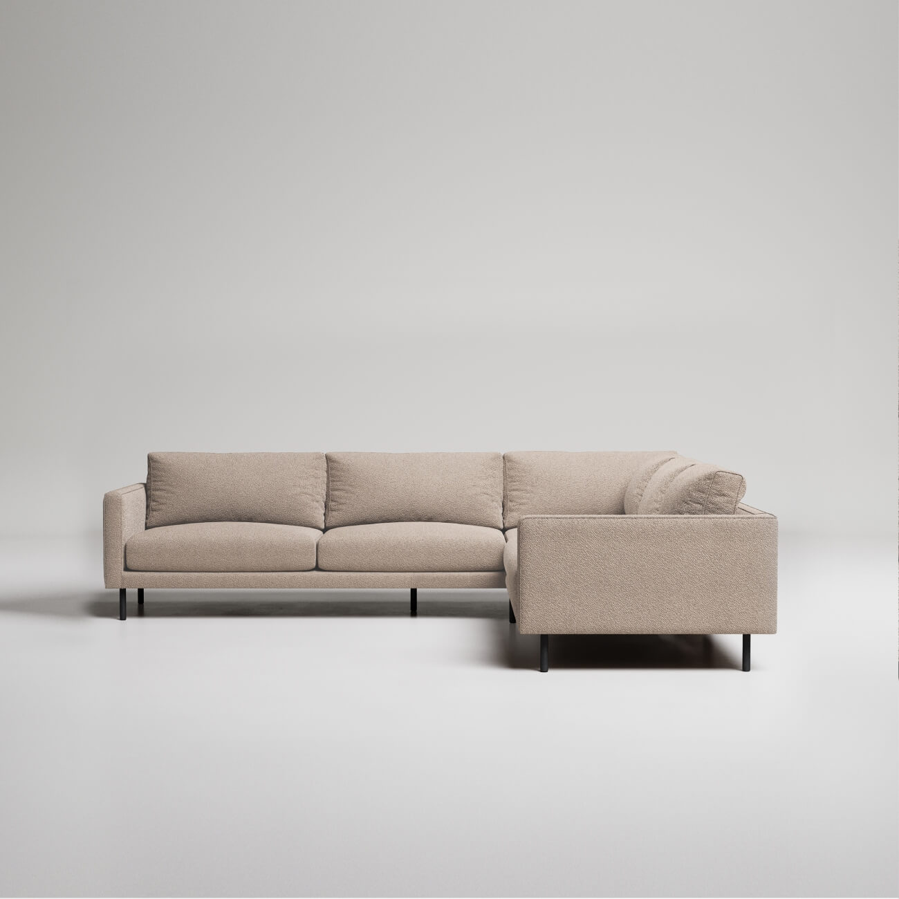 Modern L-shaped sectional sofa in beige textured fabric with black metal legs against white background