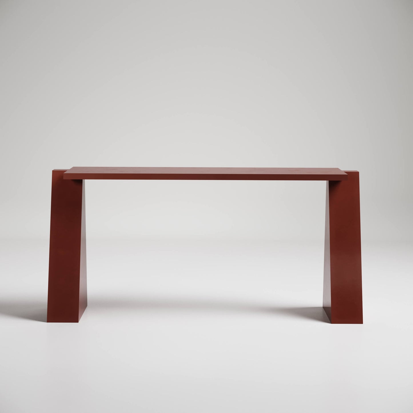 Modern minimalist console table in deep red with angular legs against white background