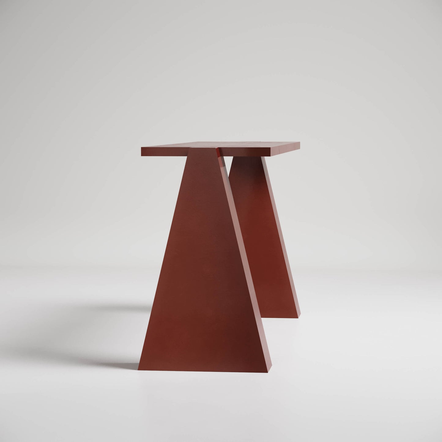 Minimalist red-brown triangular side table with geometric design against white background, modern aesthetic