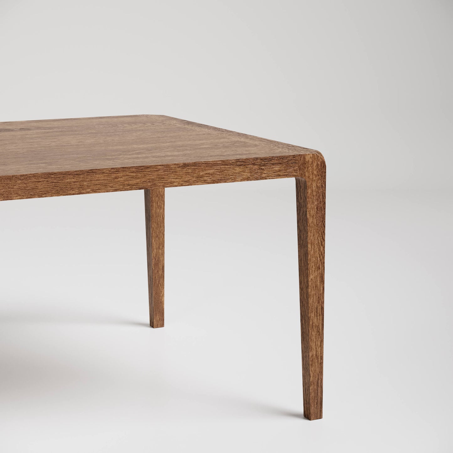 Modern minimalist wooden coffee table with tapered legs against white background, partial view