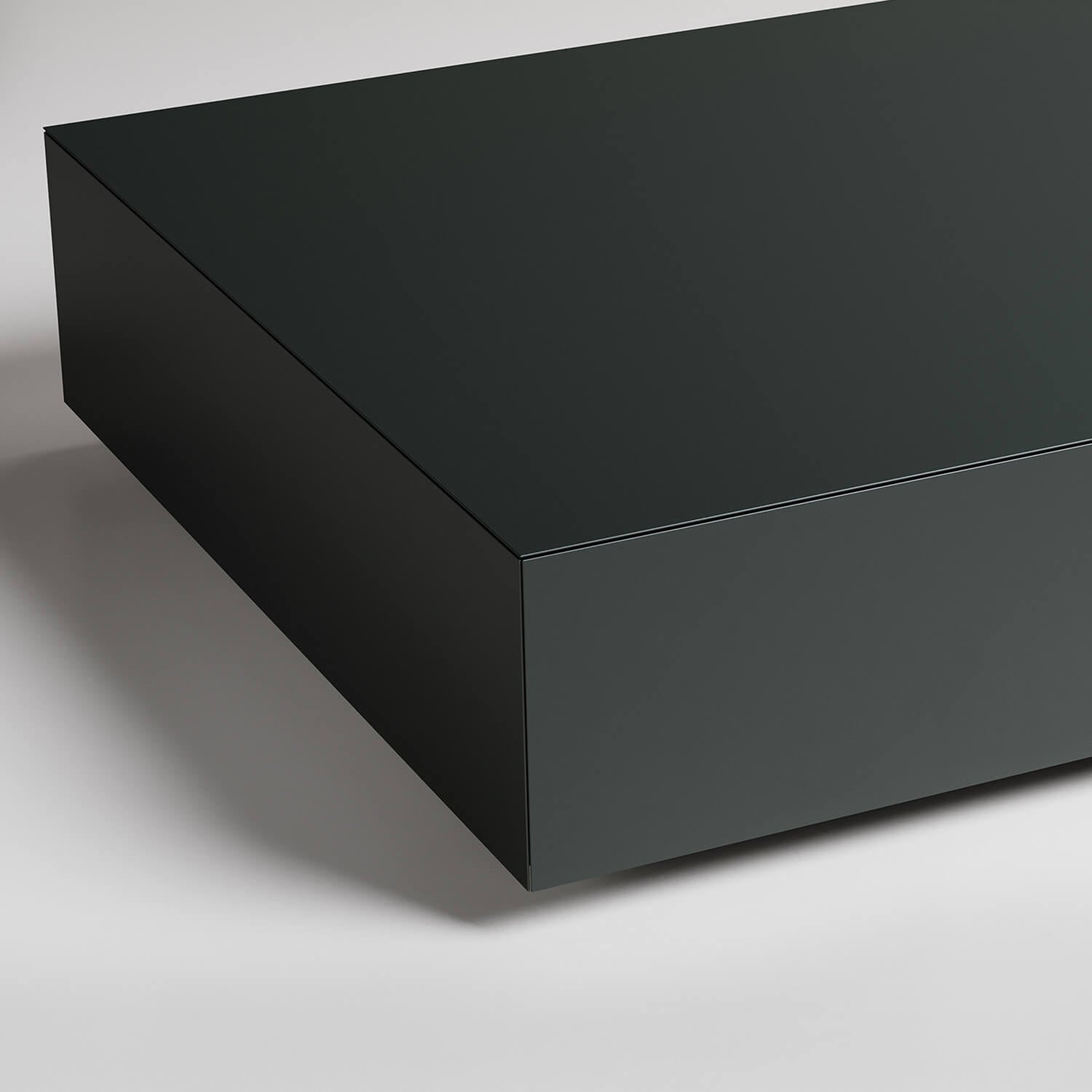 Dark minimalist rectangular floating shelf unit against white background with clean angular lines and shadow