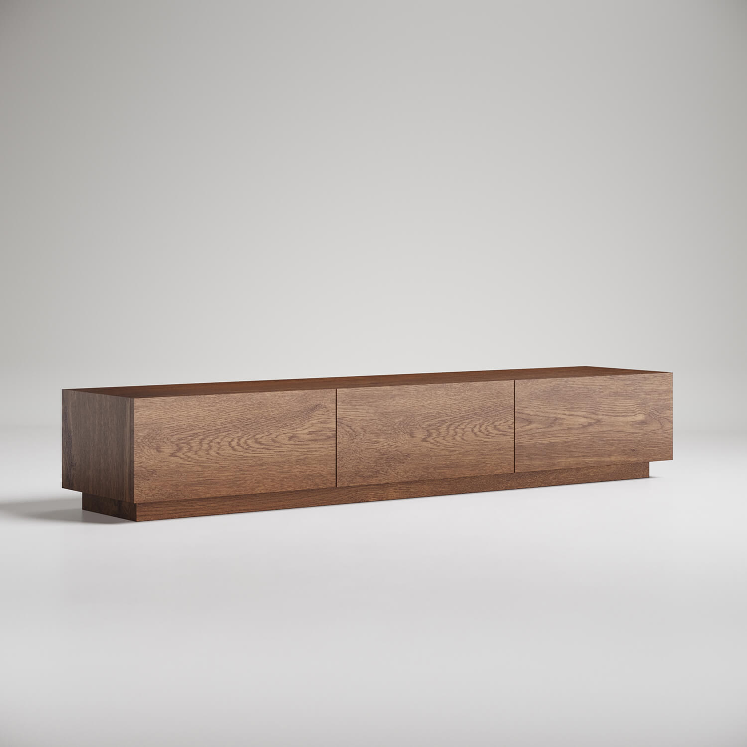 Modern low-profile wooden media console with three panels in walnut finish against white background