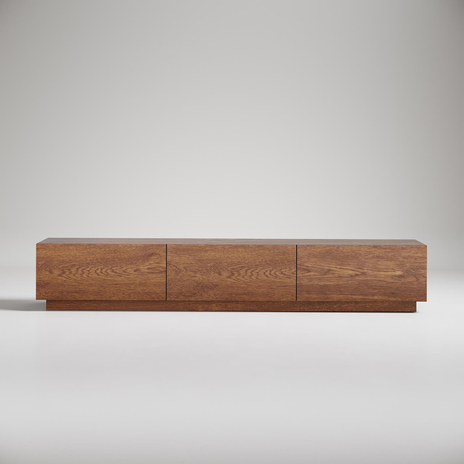Modern low-profile wooden TV stand with three drawers, minimalist design in warm oak finish against grey background