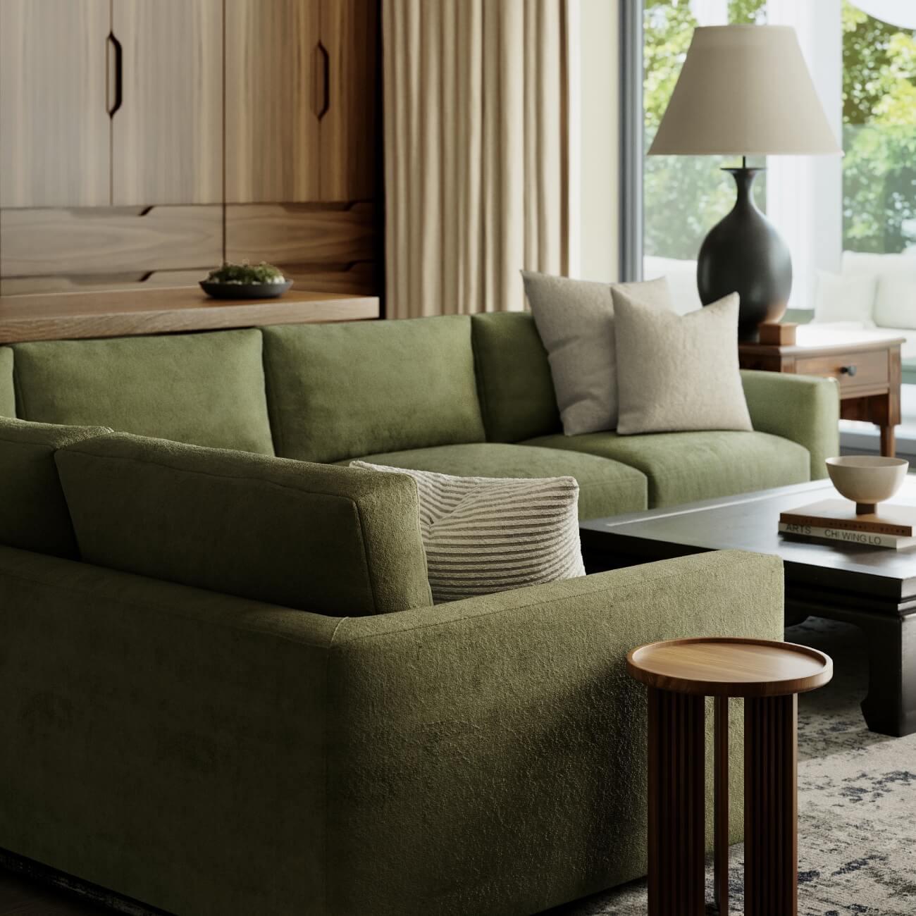 Modern living room with olive green sectional sofa, black table lamp, wooden accent table on textured gray rug