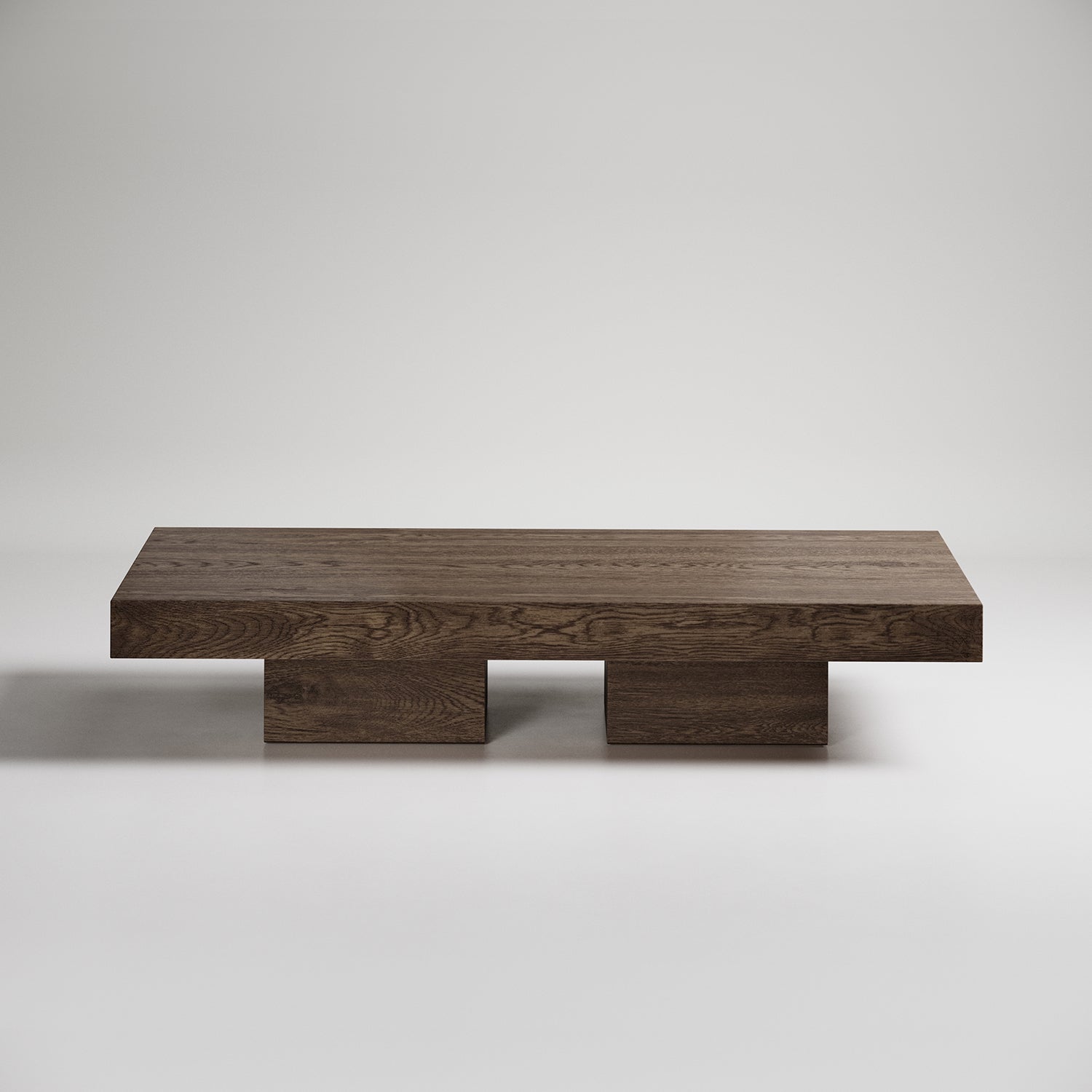 Modern low-profile coffee table with dark wood finish and minimalist geometric base design on white background