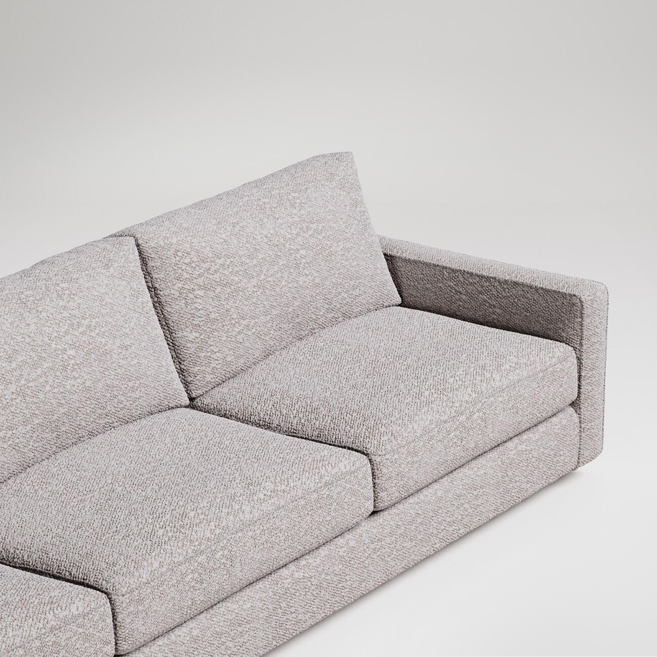 Modern gray upholstered sofa with clean lines on white background, minimalist contemporary furniture design