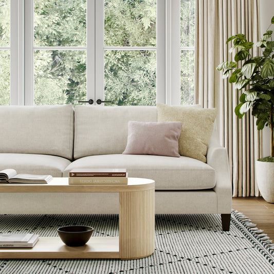 Sofa styled with cushions and textured throw