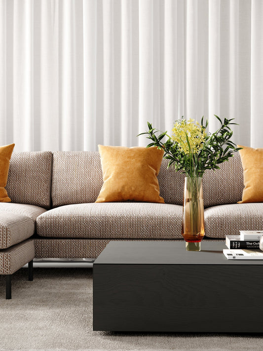 Leather sofas in Melbourne lounge accented with deep green pillows