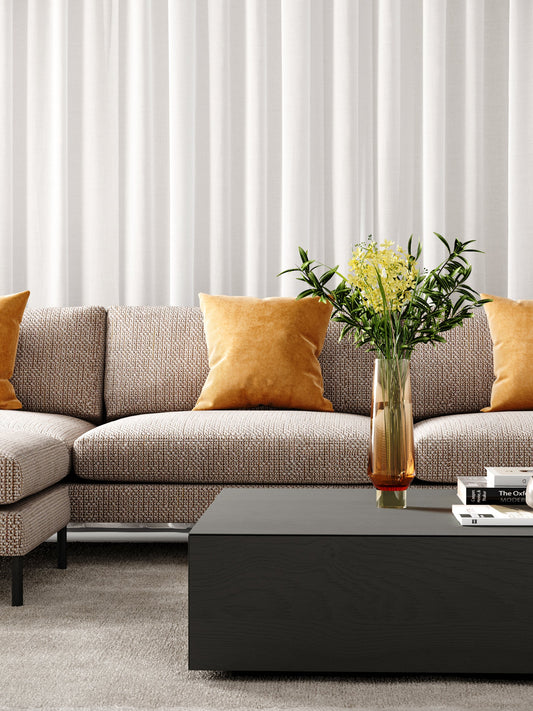 Modern grey couch in Melbourne living room with timber floors
