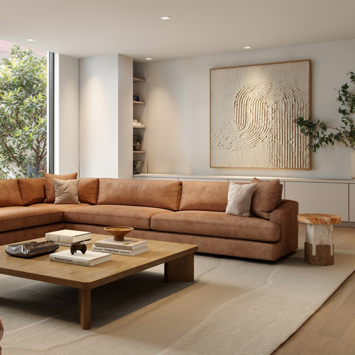 Modern living room with brown sectional sofa, wooden coffee table, and abstract wall art.