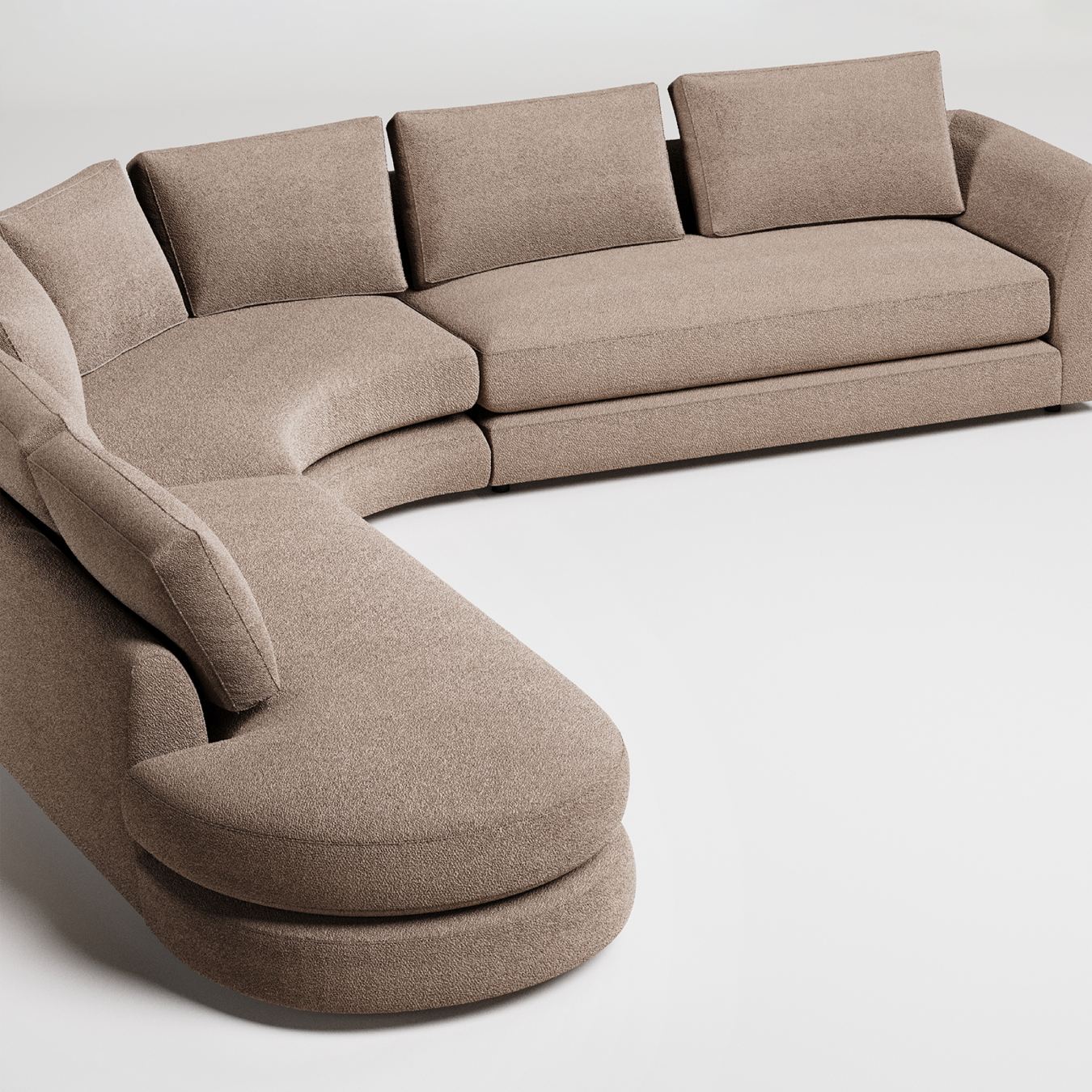 Curved camel sectional sofa with textured upholstery and clean modern lines on grey background