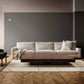 Modern living room with a gray sofa, timber coffee table and minimal decor.