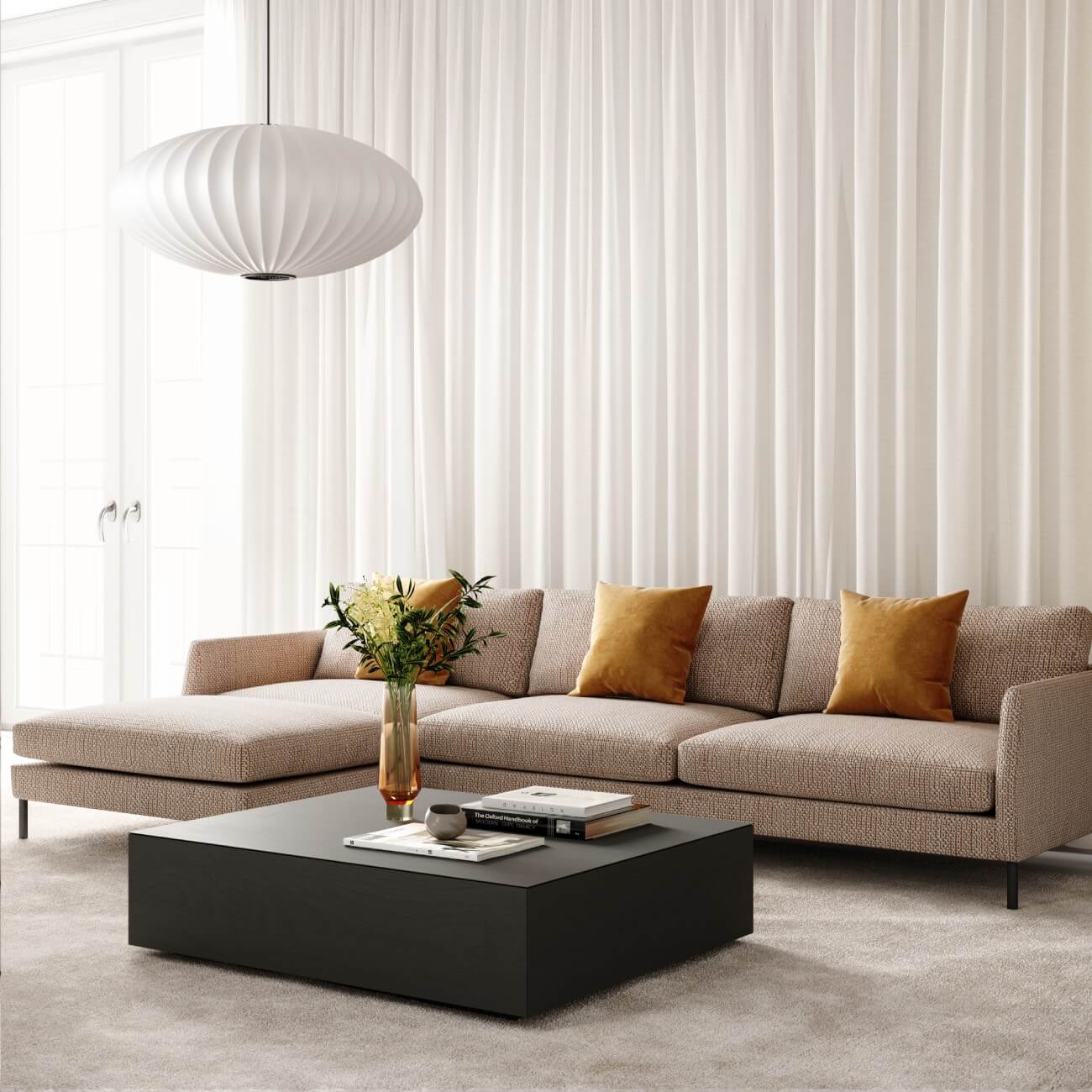 Cream sofa and chaise with a square black coffee table and white curtains in an attractive room
