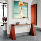 Oxblood sculptural console table on a terrazzo floor in a modern living space