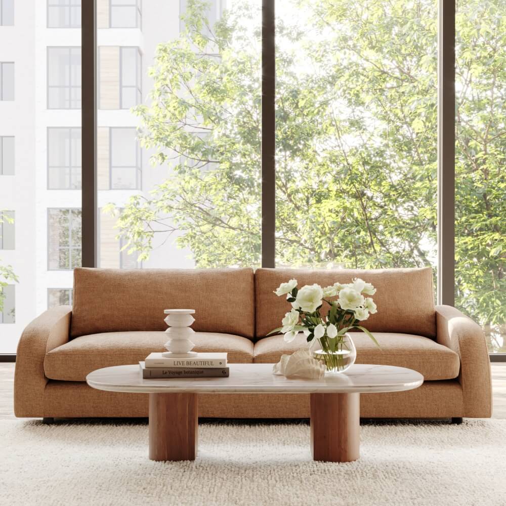  Large tan sofa and coffee table in front of picture windows