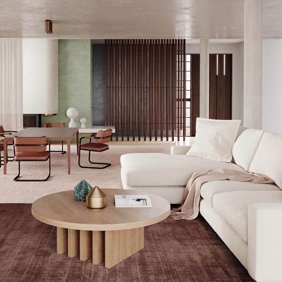 Modern living room with white sectional, wood slat divider, brown leather dining chairs and round coffee table
