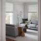 Looking through a doorway into a bright living room with two light grey sofas