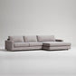 Grey sofa with two seat cushions and a large chaise